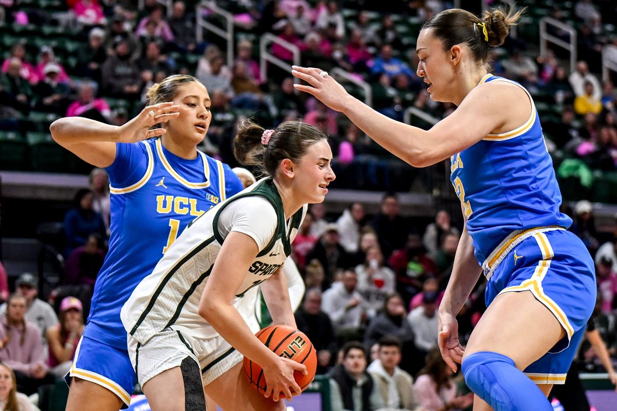 Michigan State's InŽs Sotelo, center, gets a rebound between UCLA's Sienna Betts, left, and Angela Dugalie, right, during the first quarter on Wednesday, Feb. 11, 2026, at the Breslin Center in East Lansing.