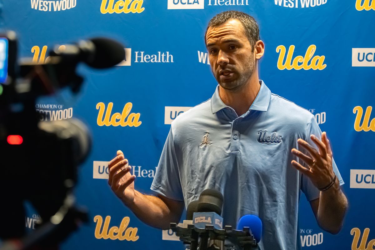 UCLA offensive coordinator Dean Kennedy answers questions from media during media day at Pavilion Club in Pauley Pavilion, Los Angeles. UCLA offensive coordinator Dean Kennedy answers questions from media during media day at Pavilion Club in Pauley Pavilion, Los Angeles.