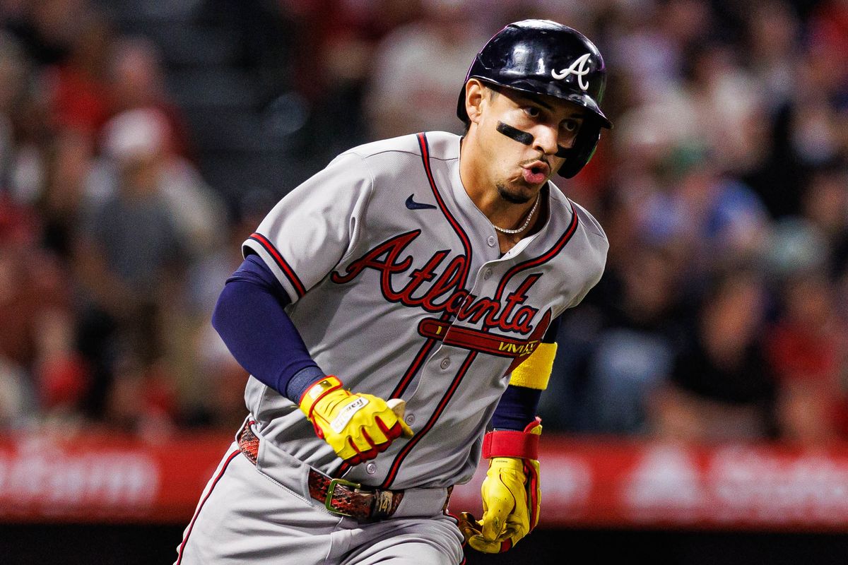 Mauricio Dubón #14 of the Atlanta Braves sprints to first base during an MLB game against the Los Angeles Angels at Angel Stadium on April 7, 2026 in Anaheim, California.