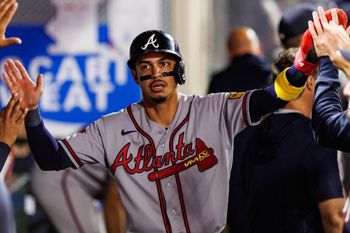 Mauricio Dubón #14 of the Atlanta Braves celebrates after scoring a run during an MLB game against the Los Angeles Angels at Angel Stadium on April 7, 2026 in Anaheim, California.