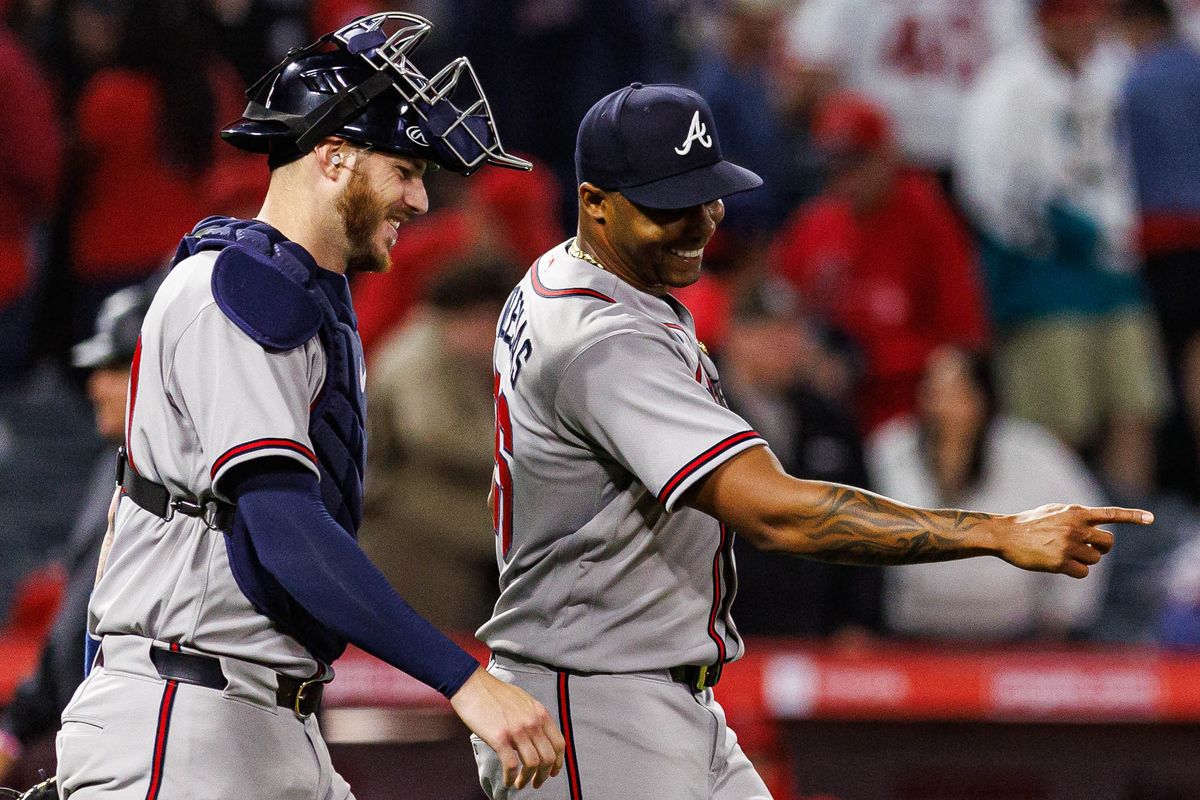Rasiel Iglesias #26 of the Atlanta Braves celebrates a victory with Jonah Heim #20 of the Atlanta Braves after an MLB game against the Los Angeles Angels at Angel Stadium on April 7, 2026 in Anaheim, California.