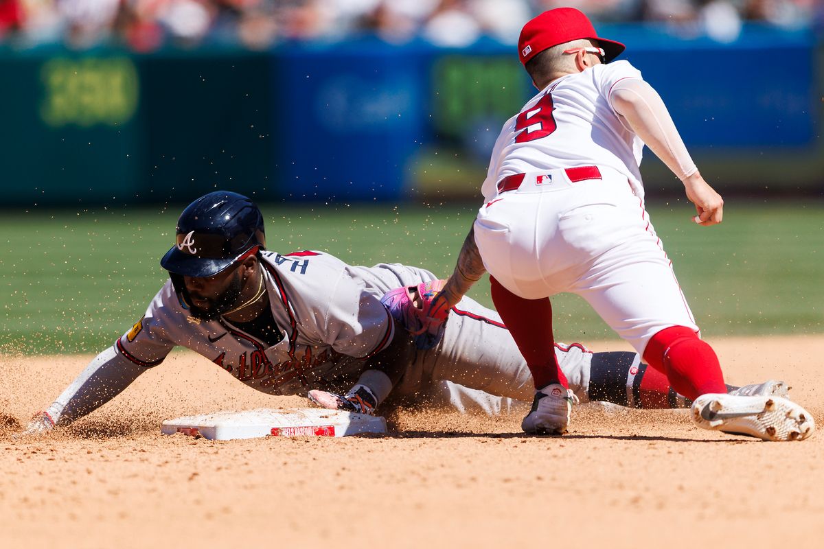 Zach Neto #9 of the Los Angeles Angels tags Michael Harris II #23 of the Atlanta Braves during the game at Angel Stadium of Anaheim on April 8, 2026 in Anaheim, California.