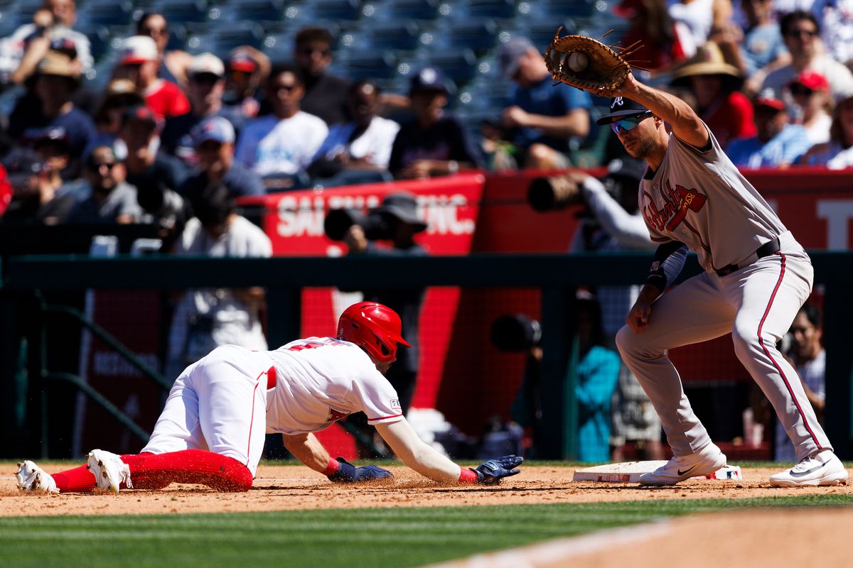Zach Neto #9 of the Los Angeles Angels dives back to first base during the game against the Atlanta Braves at Angel Stadium of Anaheim on April 8, 2026 in Anaheim, California.