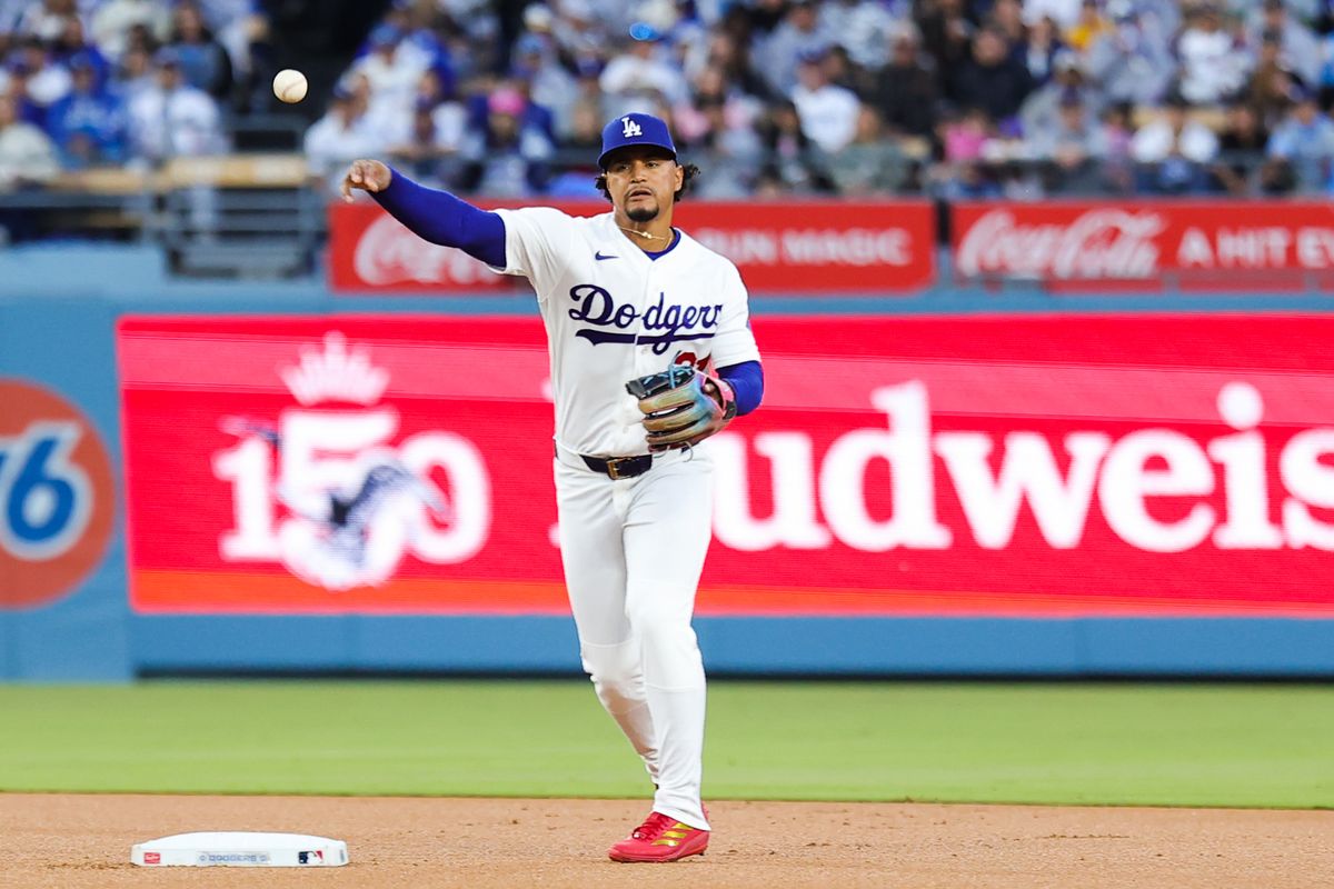 Santiago Espinal #21 of the Los Angeles Dodgers throws to third base during an MLB game against the New York Mets on April 13, 2026 in Los Angeles, CA. 