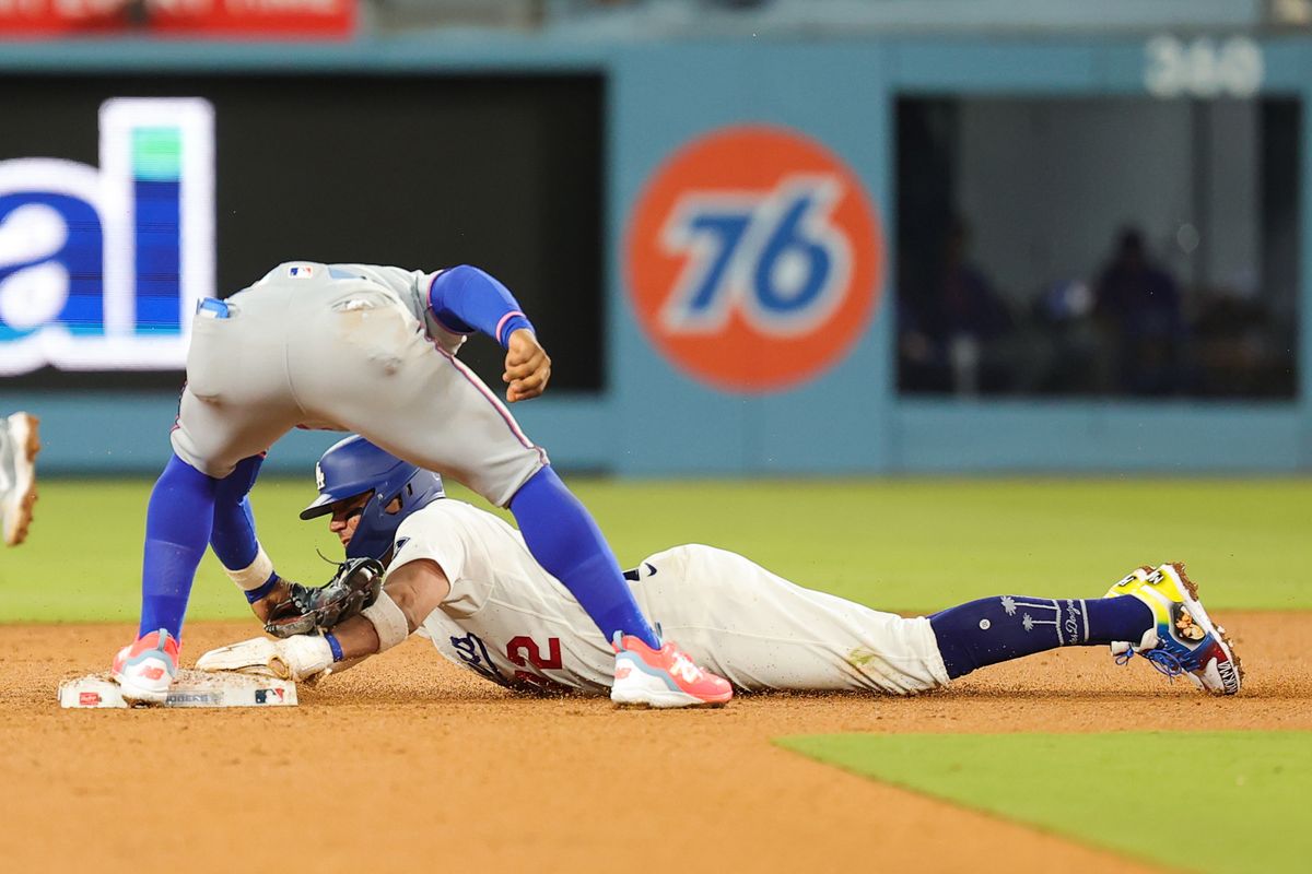 Miguel Rojas #72 of the Los Angeles Dodgers slides to second base during an MLB game against the New York Mets on April 13, 2026 in Los Angeles, CA. 