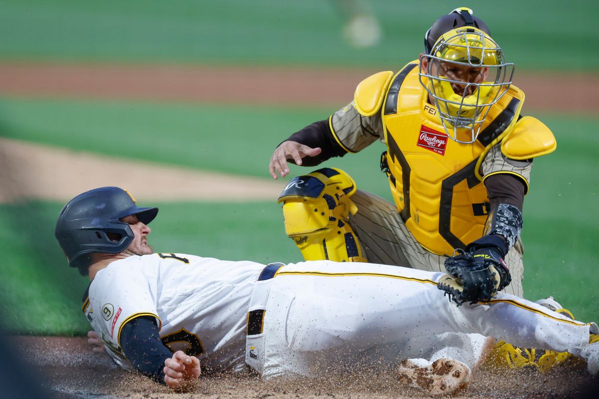 Ryan O'Hearn #29 is tagged out at home plate by Freddy Fermin #54 at PNC Park on April 6, 2025 in Pittsburgh.