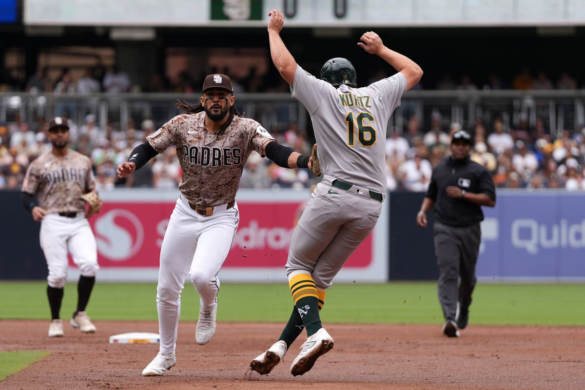 Padres right fielder Fernando Tatis Jr. (23) gets Athletics first baseman Nick Kurtz (16) out running to second base during an MLB baseball game against the Athletics, Sunday May 24, 2026 in San Diego, California.