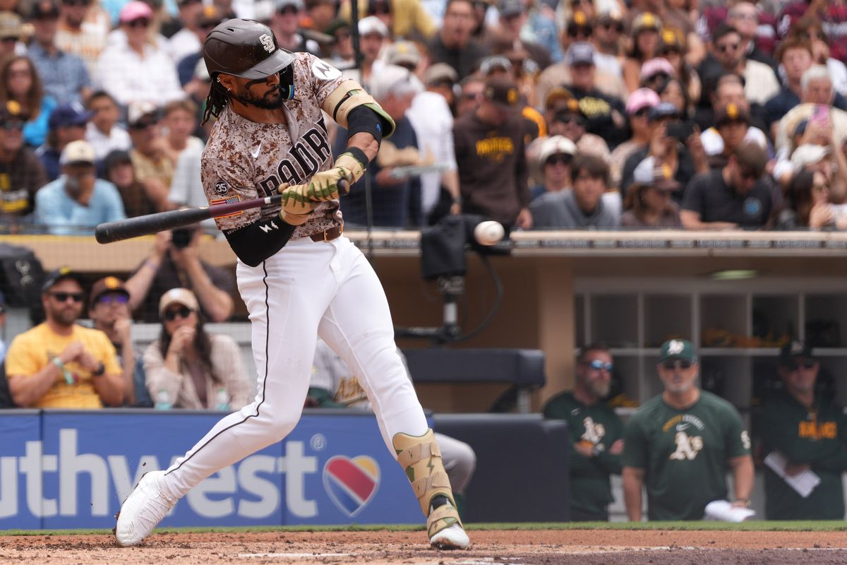 Padres right fielder Fernando Tatis Jr. (23) hits the ball during an MLB baseball game against the Athletics, Sunday May 24, 2026 in San Diego, California.