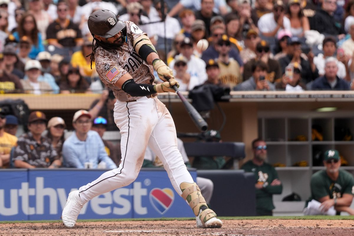 Padres right fielder Fernando Tatis Jr. (23) hits the ball during an MLB baseball game against the Athletics, Sunday May 24, 2026 in San Diego, California.
