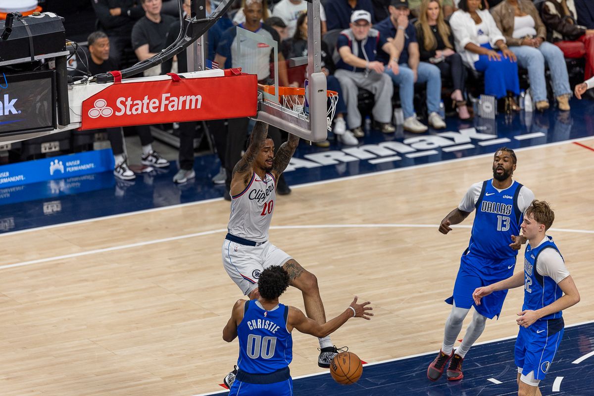 Los Angeles Clippers forward-center John Collins (20) finishes at the rim during an NBA basketball game against the Dallas Mavericks, Tuesday April 7, 2026 in Inglewood, Calif.
