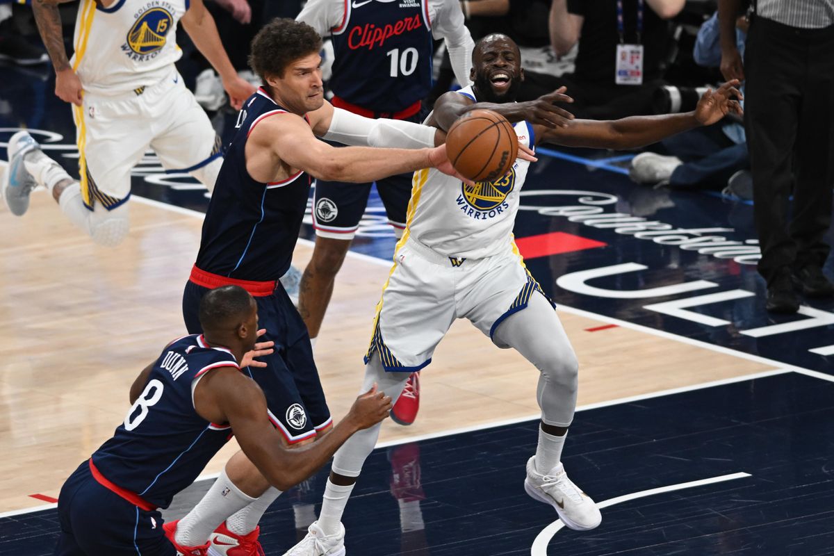 Los Angeles Clippers center Brook Lopez (11) swipes the ball away from Golden State Warriors forward Draymond Green (23) during a game between the Los Angeles Clippers and Golden State Warriors on Wednesday, April 15, 2026 at Intuit Dome in Inglewood Calif