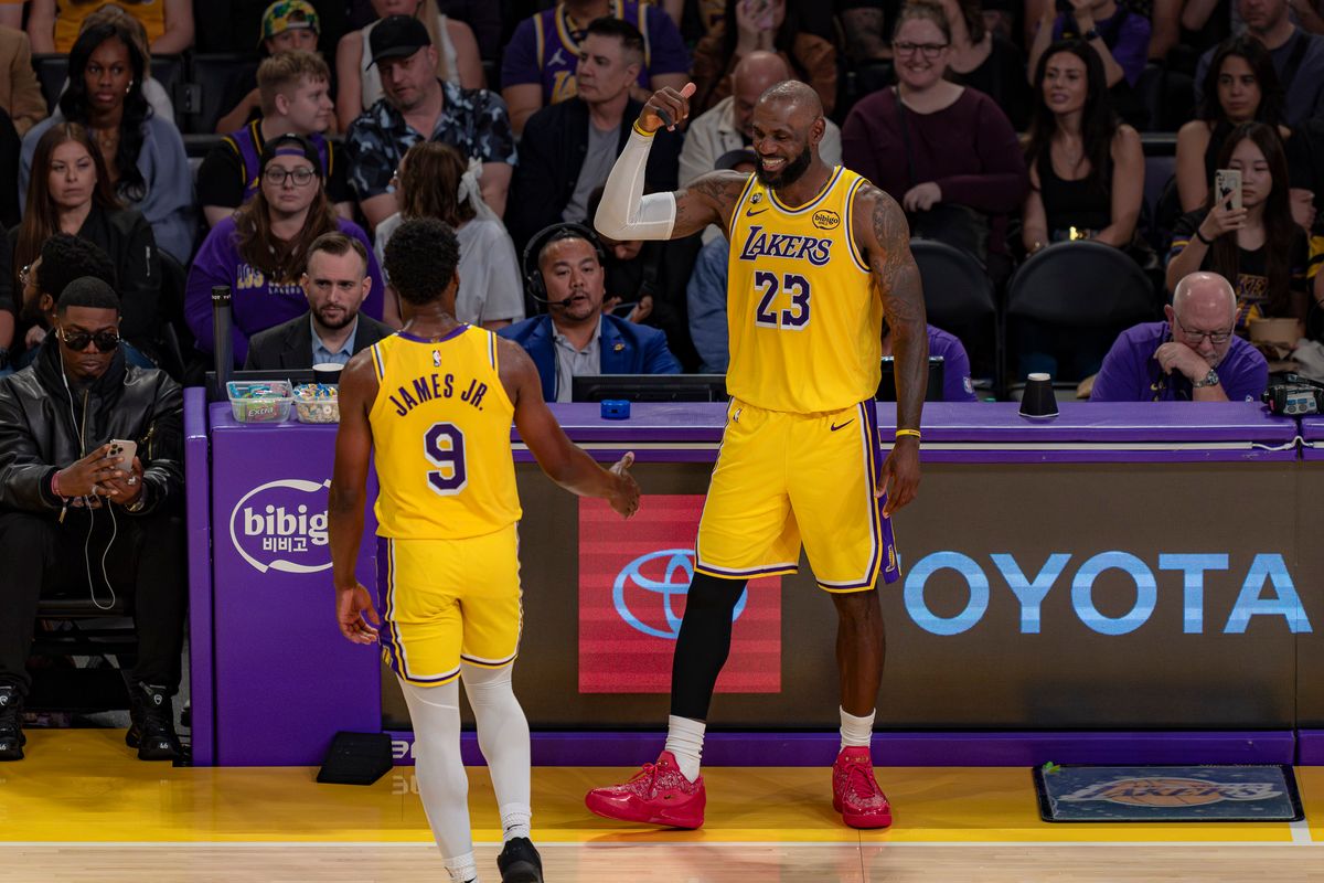 Los Angeles Lakers forward LeBron James (23) happily relieving his son Bronny James Jr. (9) from play during an NBA basketball game against the Washington Wizards on March 30th, 2026 in Los Angeles, CA.