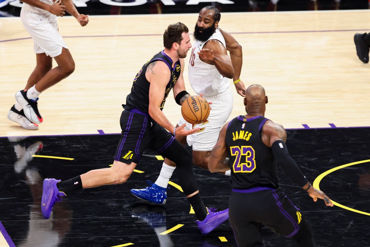 Luka Doncic #77 tosses a no look pass to LeBron James #23 of the Los Angeles Lakers during an NBA basketball game against the Cleveland Cavaliers, Tuesday March 31, 2026 in Los Angeles, Calif.