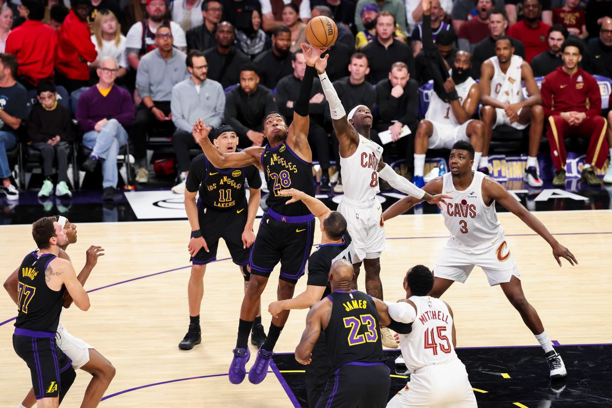 Rui Hachimura #28 of the Los Angeles Lakers and Dennis Schroder #8 of the Cleveland Cavaliers compete for a jump ball during an NBA basketball game, Tuesday March 31, 2026 in Los Angeles, Calif.