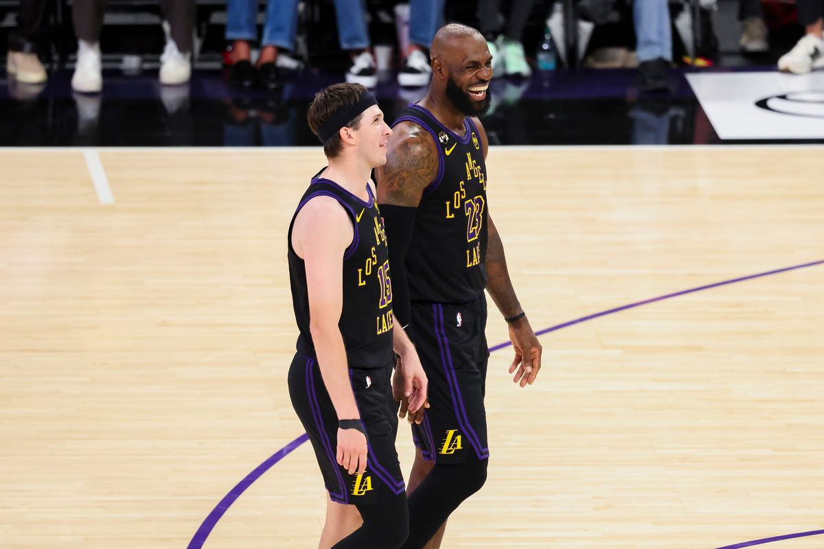 Austin Reaves #15 and LeBron James #23 of the Los Angeles Lakers have a conversation on the court during an NBA basketball game against the Cleveland Cavaliers, Tuesday March 31, 2026 in Los Angeles, Calif.