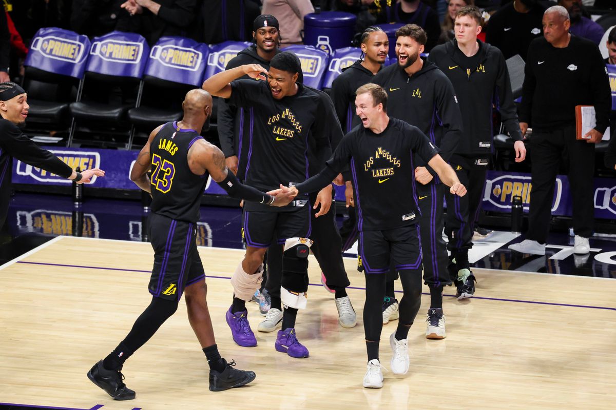 LeBron James #23 is celebrated by Rui Hachimura #28, Luke Kennard #10 and the rest of the Los Angeles Lakers bench during an NBA basketball game against the Cleveland Cavaliers, Tuesday March 31, 2026 in Los Angeles, Calif.
