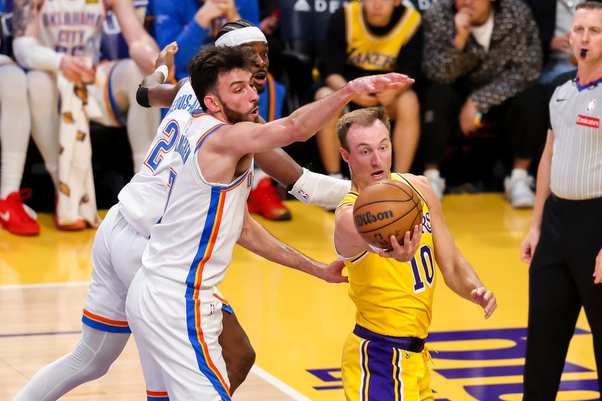 Luke Kennard #10 of the Los Angeles Lakers handles the ball against Chet Holmgren #7 and Shai Gilgeous-Alexander #2 of the Oklahoma City Thunder during an NBA basketball game, Tuesday April 7, 2026 in Los Angeles, Calif.