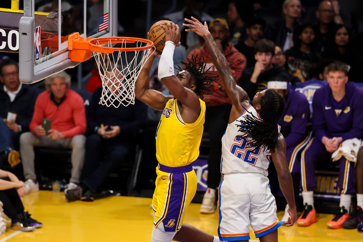 Adou Thiero #1 of the Los Angeles Lakers drives towards the rim against Cason Wallace #22 of the Oklahoma City Thunder during an NBA basketball game, Tuesday April 7, 2026 in Los Angeles, Calif.