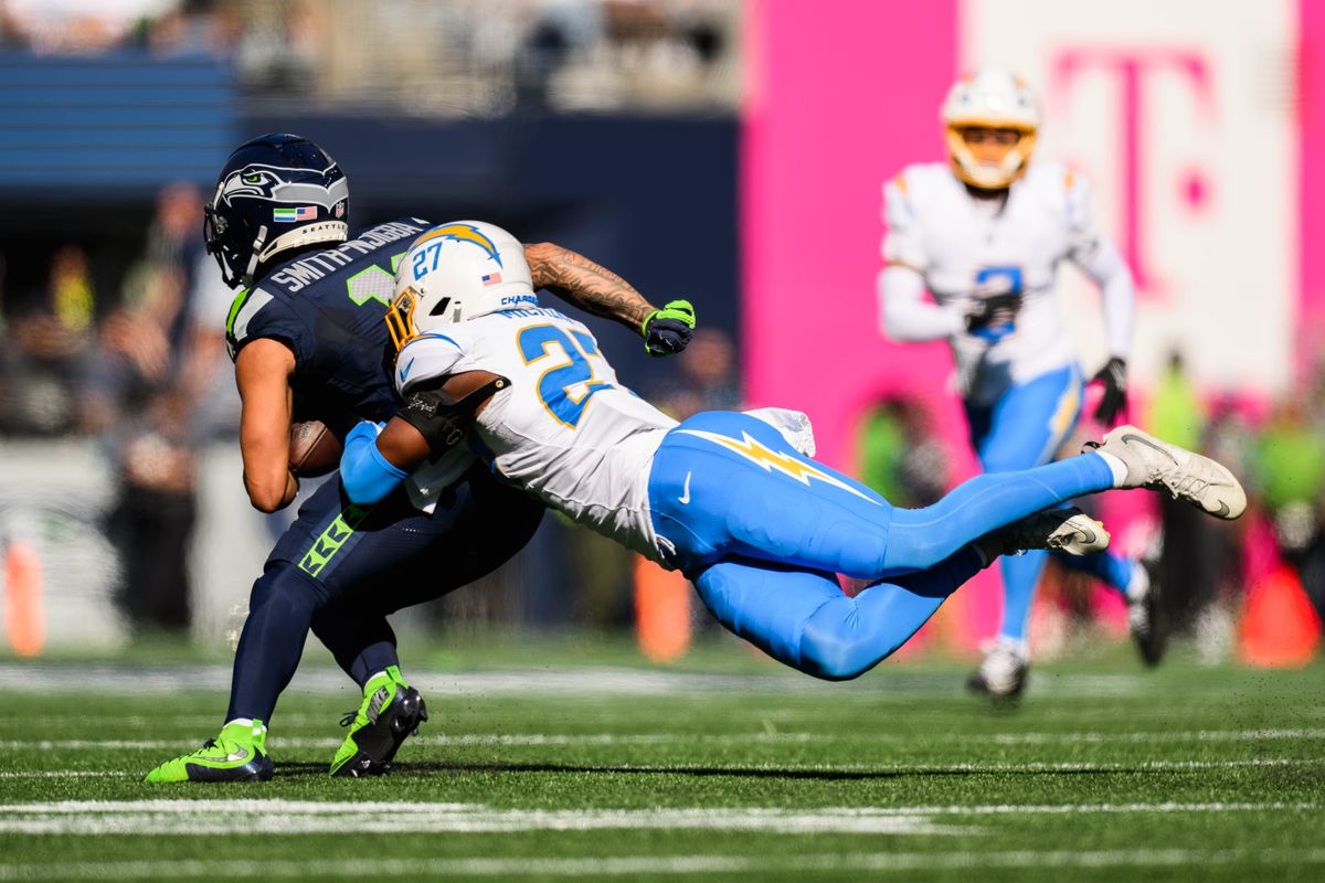 Los Angeles Chargers safety RJ Mickens (27) tackles Seattle Seahawks wide receiver Jaxon Smith-Njigba (11) during an NFL game between the Los Angeles Chargers and Seattle Seahawks on Sunday, October 4, 2026 at Lumen Field in Seattle, Washington Los Angeles Chargers safety RJ Mickens (27) tackles Seattle Seahawks wide receiver Jaxon Smith-Njigba (11) during an NFL game between the Los Angeles Chargers and Seattle Seahawks on Sunday, October 4, 2026 at Lumen Field in Seattle, Washington