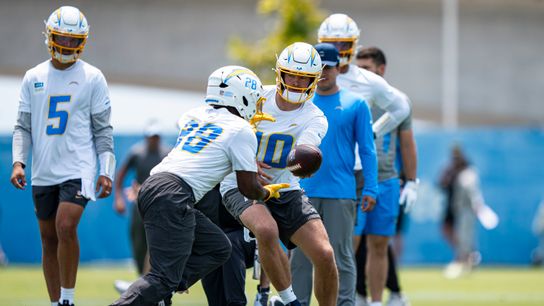 Los Angeles Chargers quarterback Justin Herbert (10) hands the ball off to running back Kimani Vidal (28) during Chargers organized team activities at the Bolt on Tuesday, June 2nd in El Segundo, CA. Los Angeles Chargers quarterback Justin Herbert (10) hands the ball off to running back Kimani Vidal (28) during Chargers organized team activities at the Bolt on Tuesday, June 2nd in El Segundo, CA.