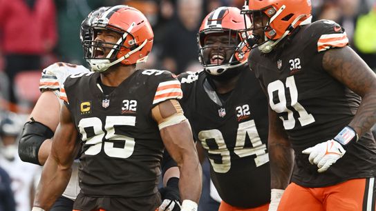 Cleveland Browns defensive end Myles Garrett (95) and defensive tackle Dalvin Tomlinson (94) and defensive end Alex Wright (91) celebrate after a tackle during the second half against the Chicago Bears at Cleveland Browns Stadium. 