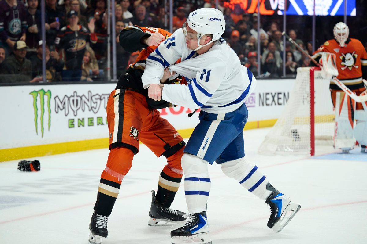 The Anaheim Ducks defender Pavel Mintyukov (98) and Toronto Maple Leafs center Max Domi fight during an NHL game against The Toronto Maple Leafs, March 30th, 2026 in Anaheim, California.