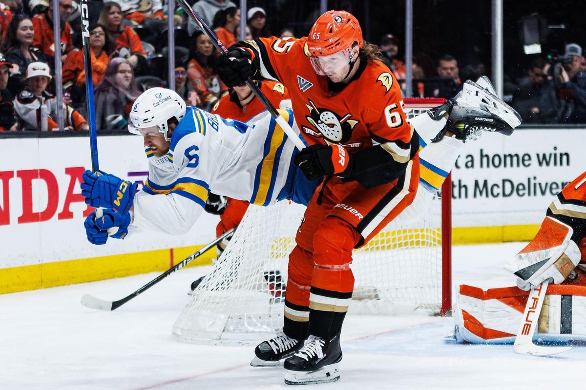 Anaheim Ducks defenseman Jacob Trouba (#65) records a hit on St. Louis Blues defenseman Philip Broberg (#6) during an NHL match against the St. Louis Blues on April 3, 2026 in Anaheim, California.