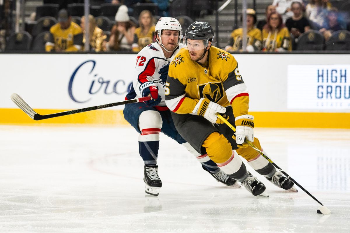 Vegas Golden Knights defenseman Jeremy Lauzon (5) looks to skate the puck out of the zone as Washington Capitals right-wing Anthony Beauvillier (72) defends during a NHL game between the Vegas Golden Knights and the Washington Capitals, Saturday March 28, 2026 in Las Vegas, Nev.