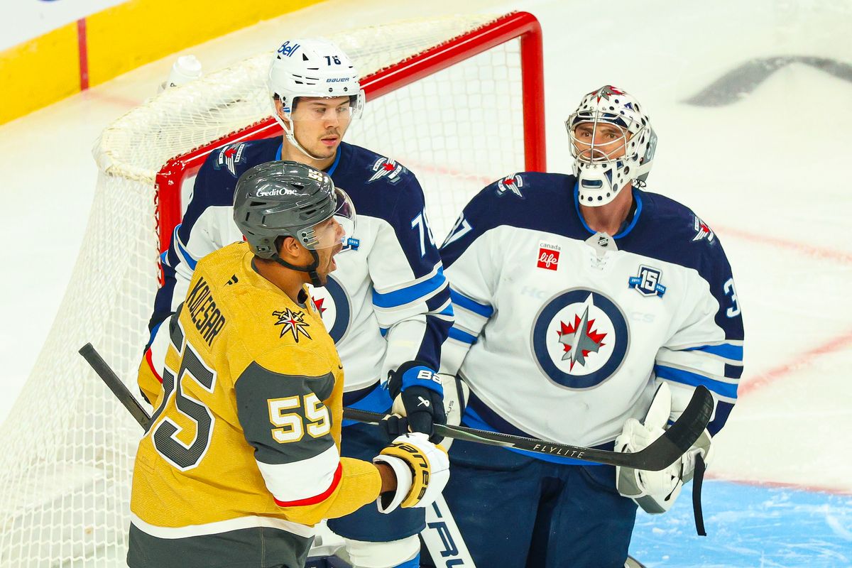 Winnipeg Jets G Connor Hellebuyck (37) stares down Vegas Golden Knights F Keegan Kolesar (55) after making a save during an NHL game on Monday, April 13, 2026, in Las Vegas, Nevada. 