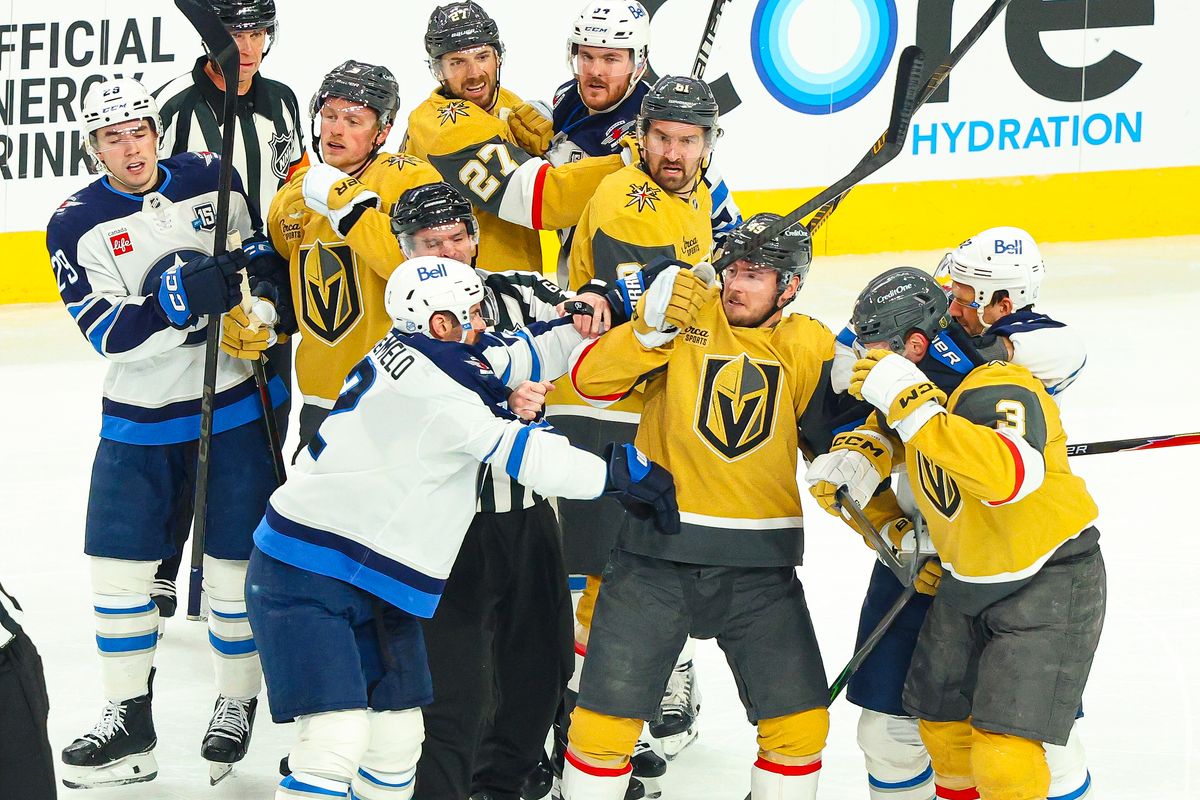 Vegas Golden Knights F Ivan Barbashev (49) and Winnipeg Jets F Nikita Chibrikov (90) each receive roughing penalties after a scrum in the second period of an NHL game on Monday, April 13, 2026, in Las Vegas, Nevada. 