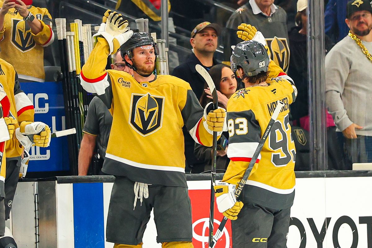 Vegas Golden Knights D Jeremy Lauzon (5) and his teammate F Mitch Marner (93) high-five after defeating the Seattle Kraken on Wednesday, April 15, 2026, in Las Vegas, Nevada. 