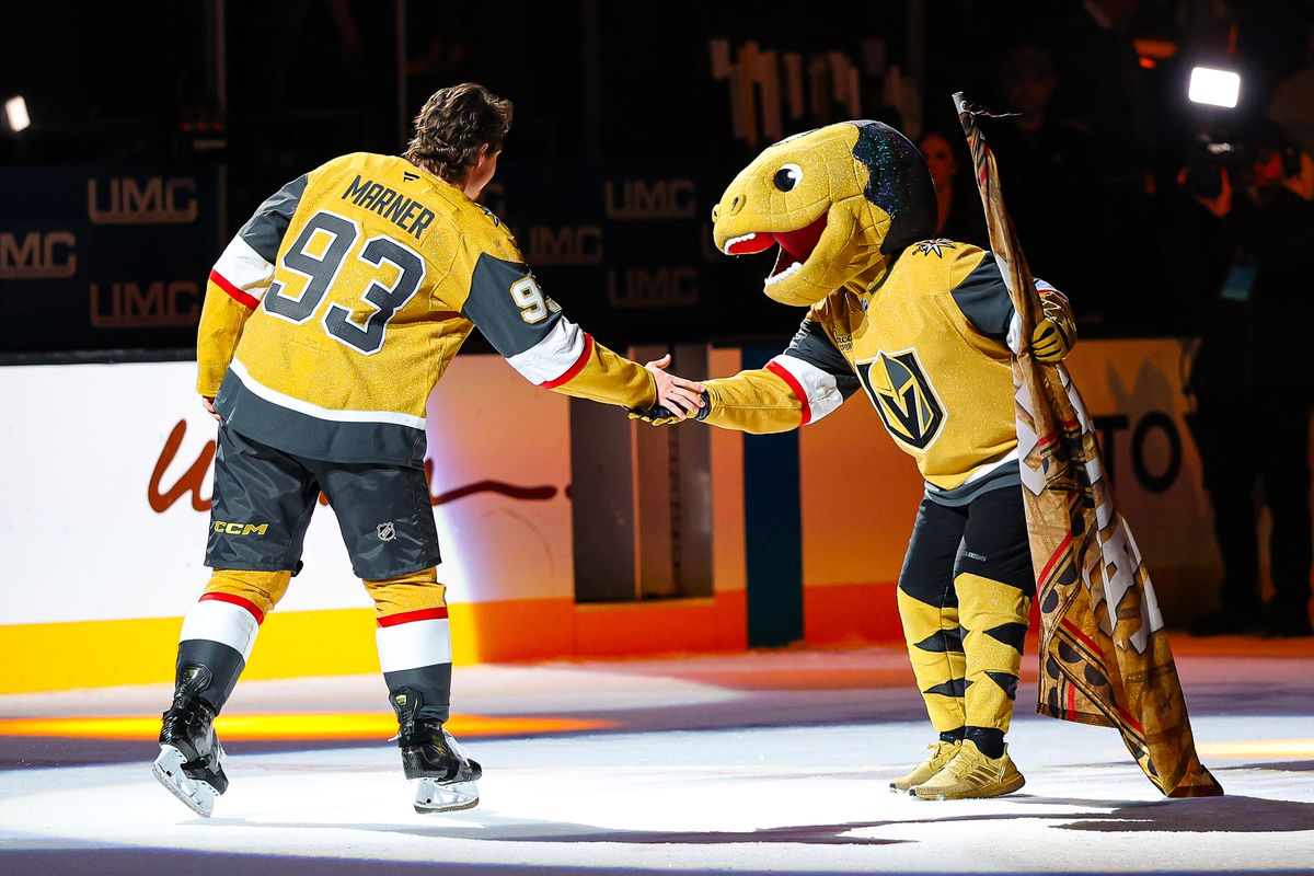 Vegas Golden Knights F Mitch Marner (93) high-fives the Vegas Golden Knights mascot Chance during the three-star ceremony after an NHL game against the Seattle Kraken on Wednesday, April 15, 2026, in Las Vegas, Nevada. 