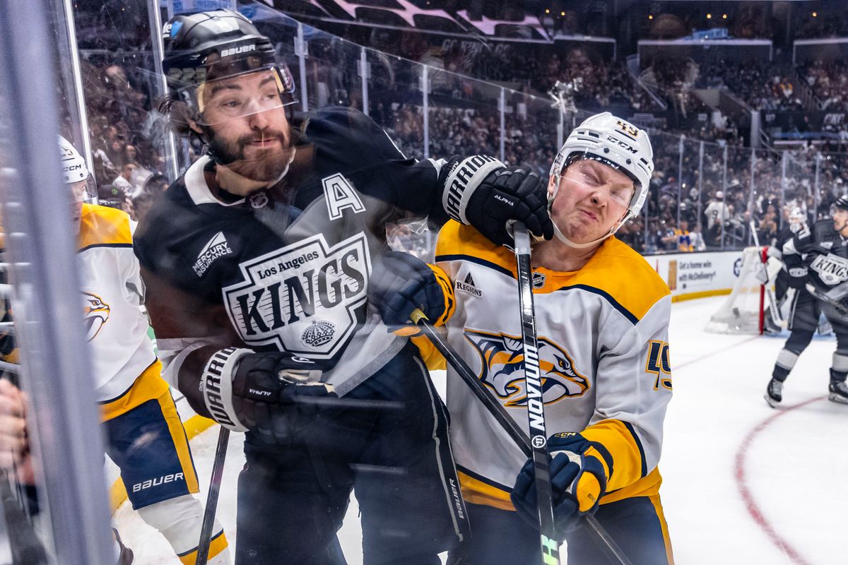 Reid Schaefer #49 of the Nashville Predators takes a fist to the face from Drew Doughty #8 of the Los Angeles Kings during an NHL hockey game, Thursday April 2, 2026 in Los Angeles, Calif.