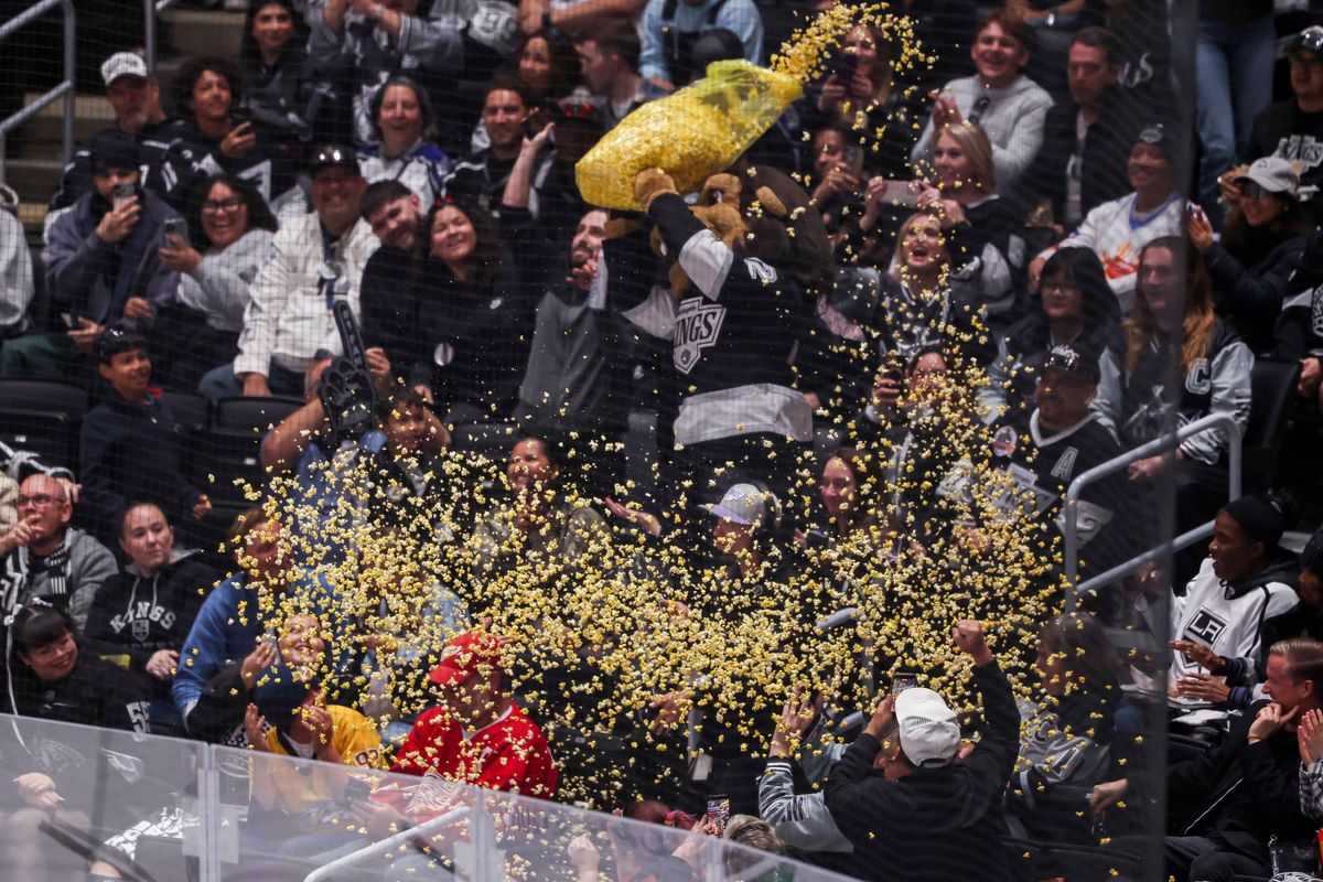 Los Angeles Kings mascot Bailey throws popcorn on fans during an NHL hockey game against the Nashville Predators, Thursday April 2, 2026 in Los Angeles, Calif.