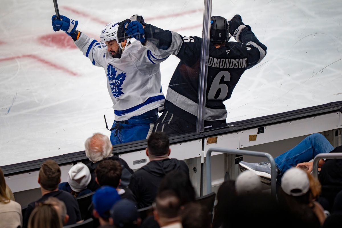 Los Angeles Kings defenseman Joel Edmundson (6) being crushed against the glass during an NHL hockey game against the Toronto Maple Leafs on April 4th, 2026 in Los Angeles, CA.