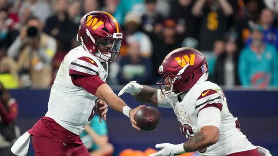 Nov 16, 2025; Madrid, Spain; Washington Commanders quarterback Marcus Mariota (8) hands the ball to Washington Commanders running back Chris Rodriguez Jr. (36) against the Miami Dolphins in the third quarter during the 2025 NFL Madrid Game at Santiago Bernabeu Stadium. 