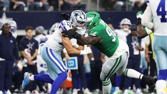 Nov 23, 2025; Arlington, Texas, USA; Dallas Cowboys tight end Jake Ferguson (87) is tackled by Philadelphia Eagles defensive tackle Jordan Davis (90) in the first quarter at AT&T Stadium.