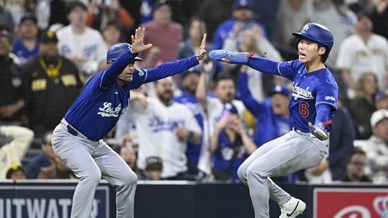 Los Angeles Dodgers third base coach Dino Ebel (91) holds shortstop Hyeseong Kim (6) at third base during the sixth inning against the San Diego Padres at Petco Park. 