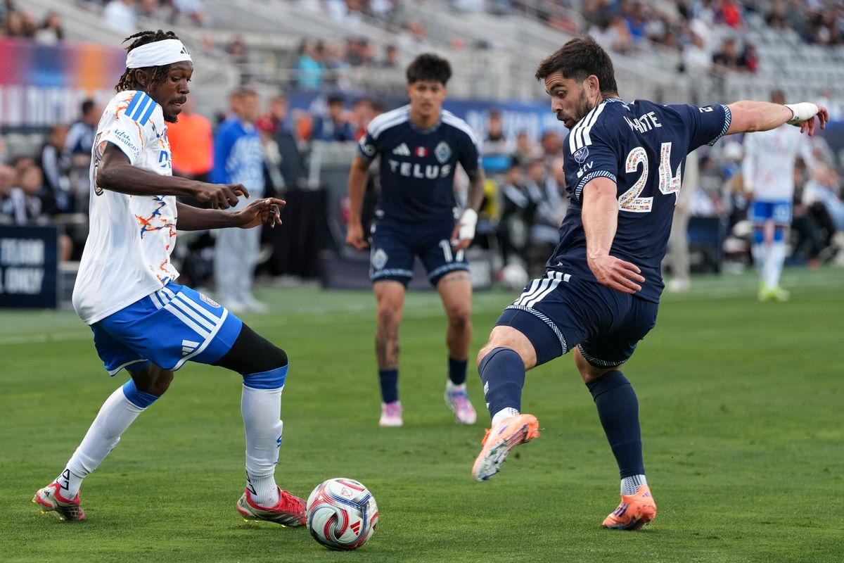 San Diego FC midfielder Manu Duah (26) dribbles past Vancouver Whitecaps forward Brian White (24) during an MLS soccer game against the Vancouver Whitecaps, Saturday May 23, 2026 in San Diego, California. San Diego FC midfielder Manu Duah (26) dribbles past Vancouver Whitecaps forward Brian White (24) during an MLS soccer game against the Vancouver Whitecaps, Saturday May 23, 2026 in San Diego, California.