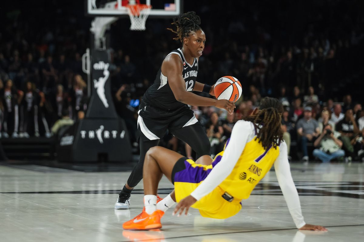 Las Vegas Aces guard Chelsea Gray (12) dribbles the ball as Los Angeles Sparks guard Ariel Atkins (7) trips during a WNBA game between the Las Vegas Aces and the Los Angeles Sparks, Saturday May 23, 2026 in Las Vegas, Nev. Las Vegas Aces guard Chelsea Gray (12) dribbles the ball as Los Angeles Sparks guard Ariel Atkins (7) trips during a WNBA game between the Las Vegas Aces and the Los Angeles Sparks, Saturday May 23, 2026 in Las Vegas, Nev.